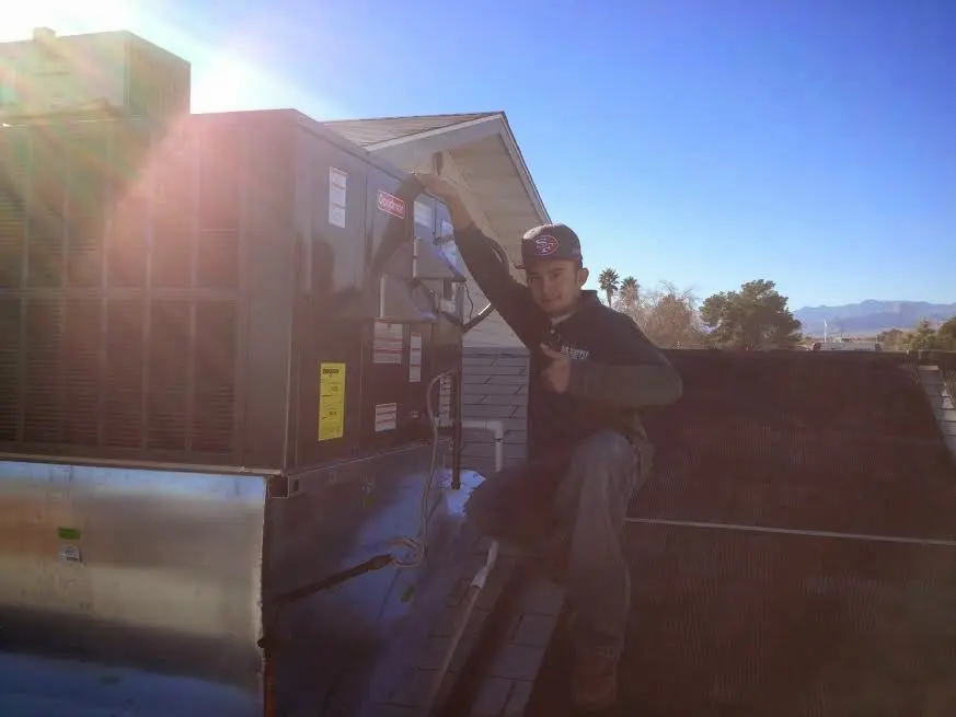 HVAC technician performing AC Tune-Up on a rooftop unit in Clearlake